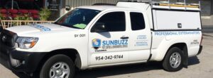 A Sunbuzz Pest Control & Environmental Services truck parked outside a commercial building in Fort Lauderdale, FL.
