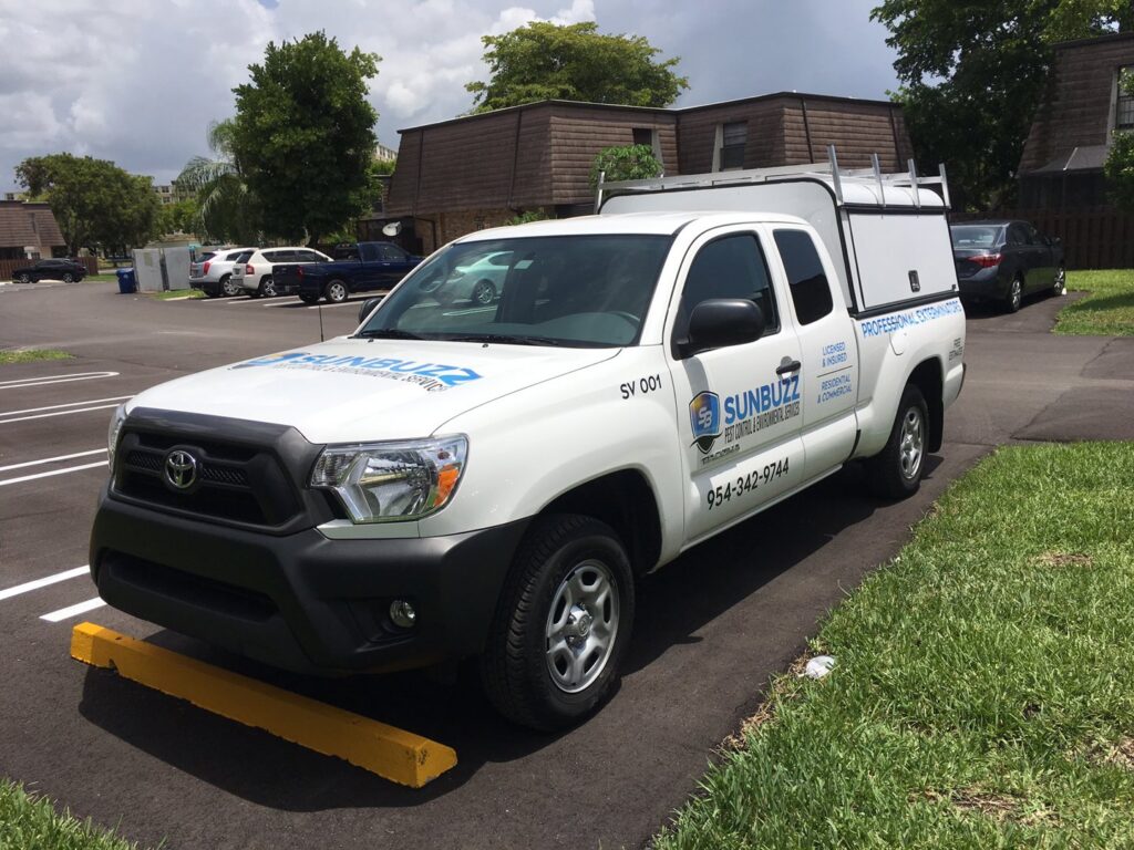 A Sunbuzz Pest Control & Environmental Services truck parked in a commercial parking lot in Fort Lauderdale, FL.