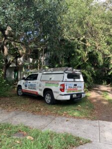 A Sunbuzz Pest Control & Environmental Services truck parked in a residential driveway in Fort Lauderdale, FL, for a service appointment.
