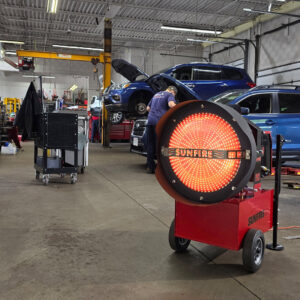A SunFire industrial heater warming a construction project with a worker in Janesville, WI