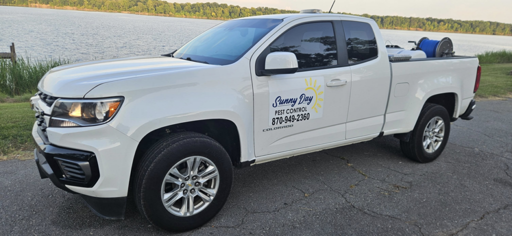 The Sunny Day Pest Control service truck with equipment in the bed, ready for a job in Pine Bluff, AR.