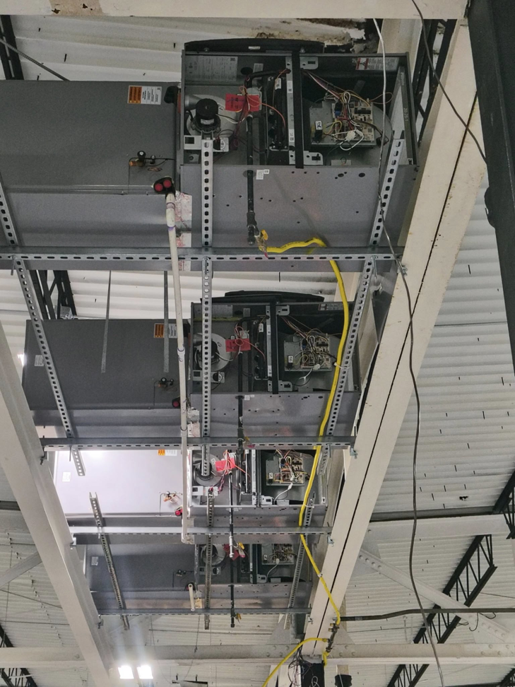 Multiple suspended HVAC air handler units with exposed components installed by Aaron's Affordable Ac in Indianapolis, IN.