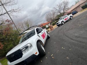 Two SWAT It Pest Control trucks parked on a residential street in Tempe, AZ, ready for service.