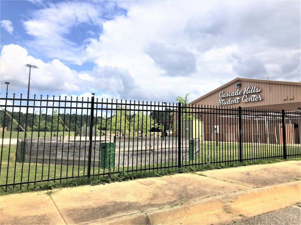 A tall black metal commercial fence with pointed finials installed by United Fence Company in Johnston, RI.