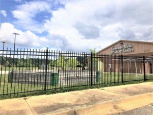 A tall black metal commercial fence with pointed finials installed by United Fence Company in Johnston, RI.