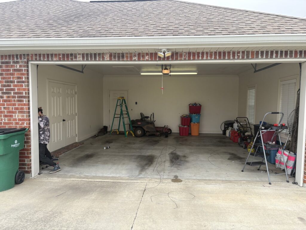 A tall ladder positioned for servicing a commercial garage door, indicating professional work by Cajun Doors & More in Lafayette, LA.