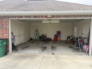A tall ladder positioned for servicing a commercial garage door, indicating professional work by Cajun Doors & More in Lafayette, LA.