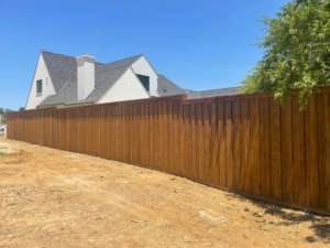 A tall, newly installed wood privacy fence enclosing a residential property by 3M Custom Fence in Lewisville, TX.