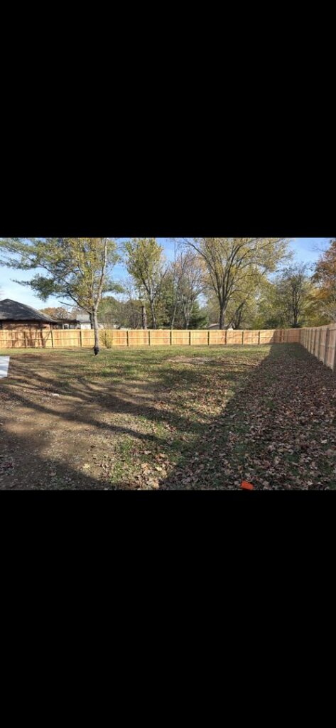 A tall wooden privacy fence installed in a residential backyard by Fenceworks of Middle Tennessee in Nashville, TN.