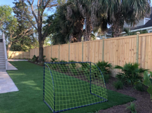 A tall wooden privacy fence installed in a residential backyard by Lowcountry Home Works843 LLC in Summerville, SC.