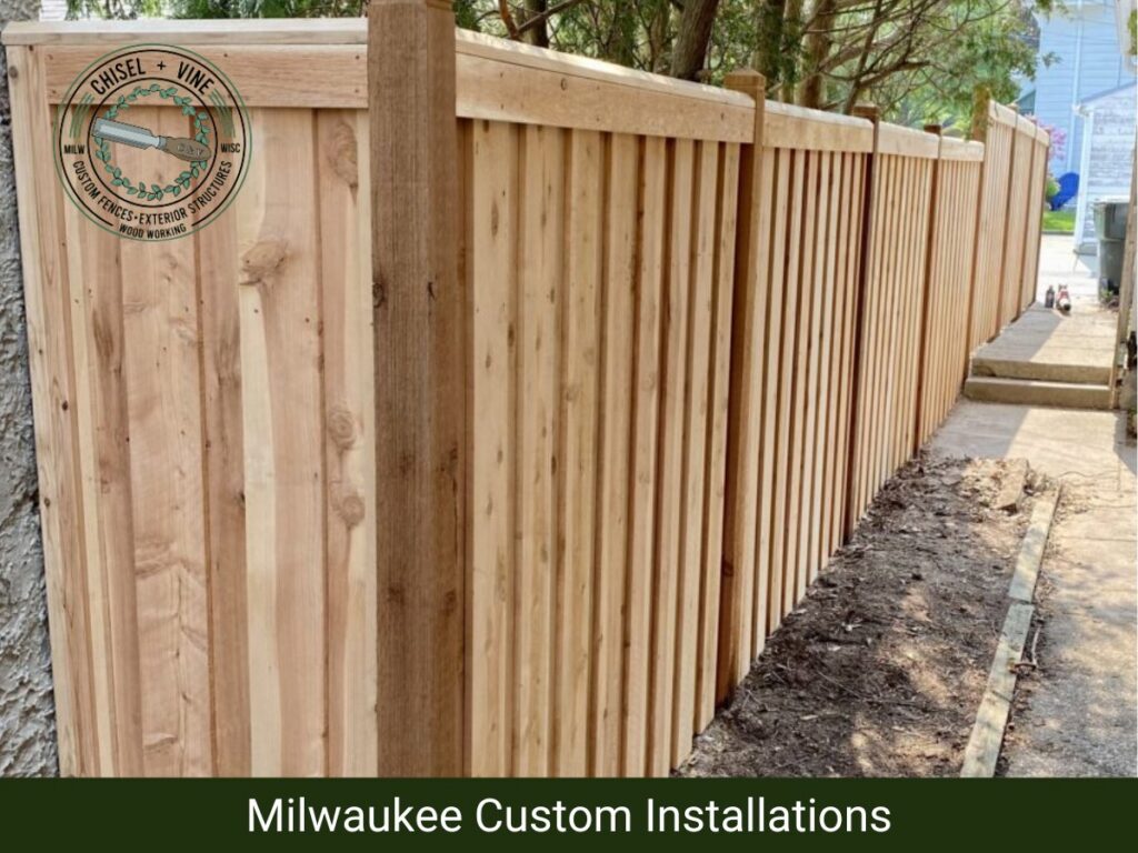 A tall, newly installed wooden privacy fence providing seclusion for a backyard by Chisel + Vine in Milwaukee, WI.
