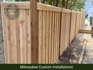 A tall, newly installed wooden privacy fence providing seclusion for a backyard by Chisel + Vine in Milwaukee, WI.