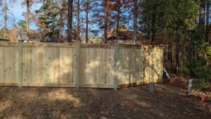 A tall wooden privacy fence installed along a property line by Gifford Contracting & Repair - Custom Privacy Fencing in Goose Creek, SC.