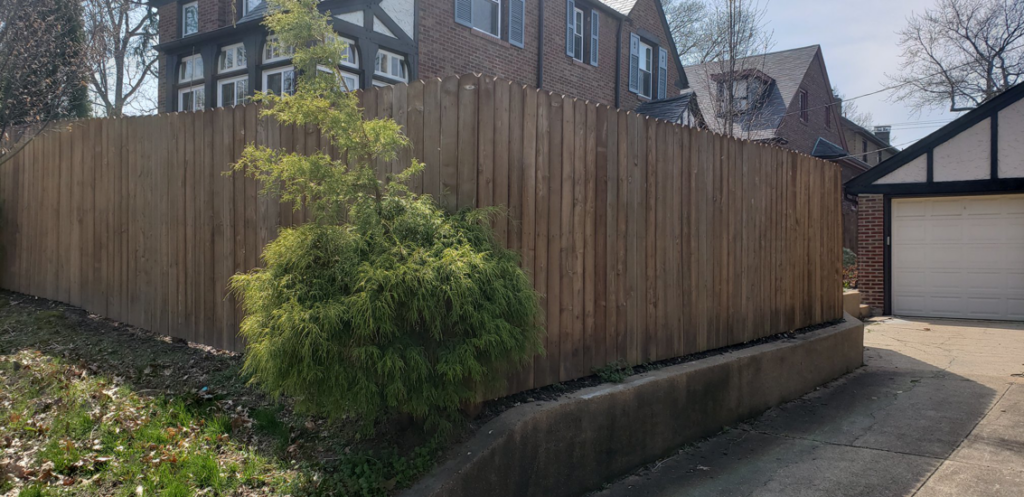 A tall wooden privacy fence enclosing a residential property, installed by Columbia Fence Co. in Columbia Station, OH.