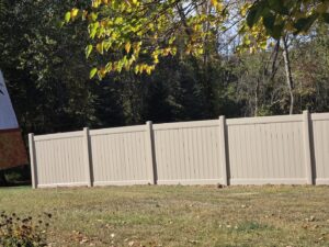 A tan privacy fence installed in a residential backyard by Hi-T Fence Systems in Waterford, PA.