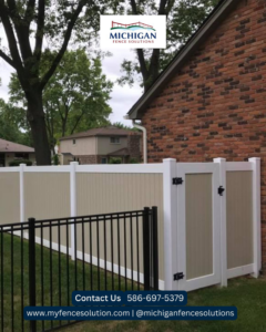 A tan and white privacy fence with a gate and black aluminum fence section by Michigan Fence Solutions in Macomb, MI.