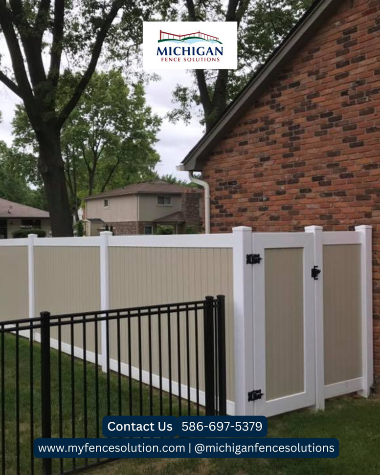 A tan and white privacy fence with a gate and black aluminum fence section by Michigan Fence Solutions in Macomb, MI.