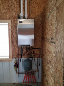 A newly installed IBC tankless boiler system with radiant floor heating manifold by Matt Moeller Heating and Cooling Llc in Stewartville, MN