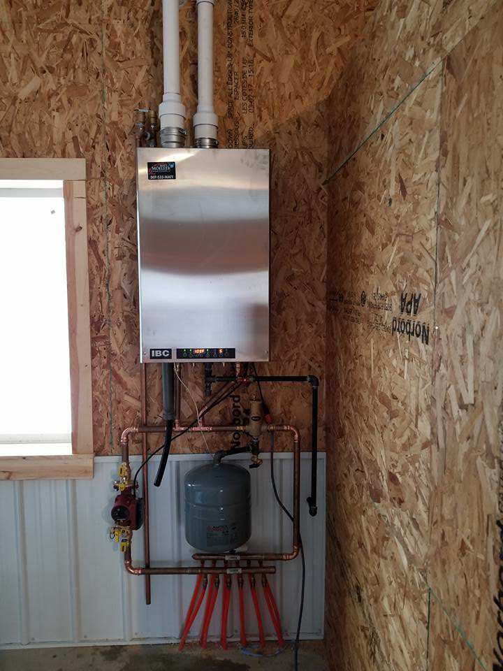A newly installed IBC tankless boiler system with radiant floor heating manifold by Matt Moeller Heating and Cooling Llc in Stewartville, MN