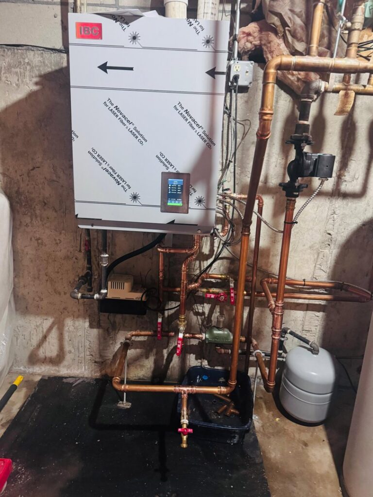 A modern tankless boiler or water heater system with copper piping installed by Express Home Services LLC in Las Vegas, NV.