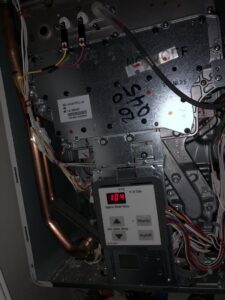 An interior view of a tankless water heater or boiler control panel displaying temperature by Service Experts Denver in Westminster, CO