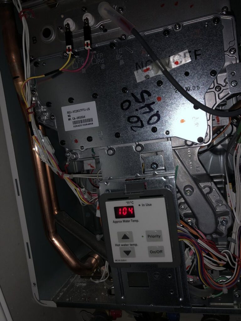 An interior view of a tankless water heater or boiler control panel displaying temperature by Service Experts Denver in Westminster, CO