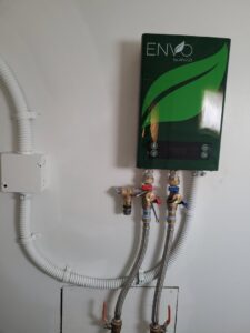 Electrical installation for a tankless water heater with visible conduit and wiring by Ant Power Electric in Tacoma, WA.