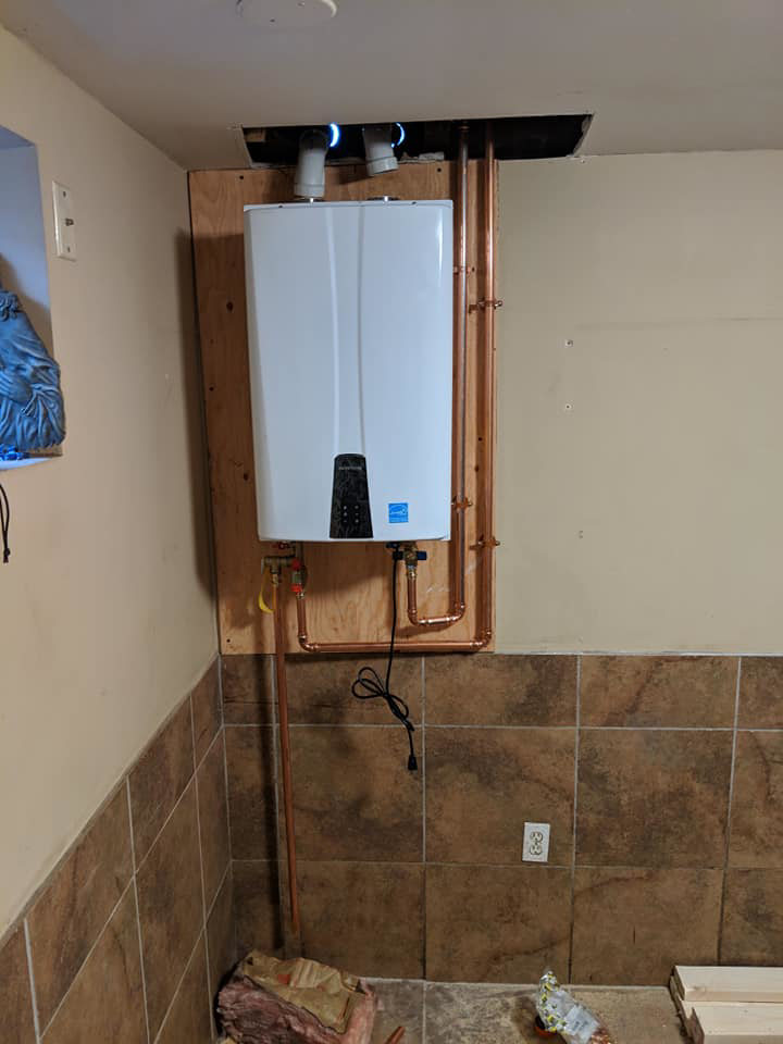 A newly installed tankless water heater with copper piping by A&T Mechanical in Edmond, OK