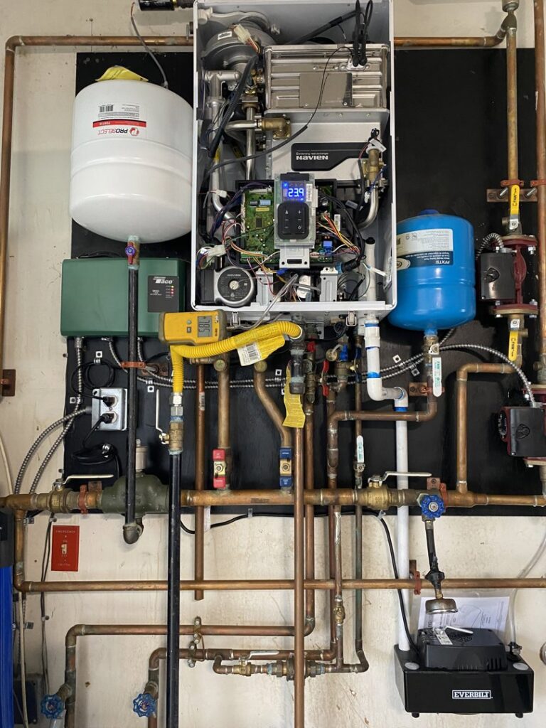An intricate tankless water heater and hydronic piping system installed by Air We Are in Toms River, NJ.