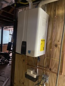 A new tankless water heater installed on a wall by Best Plumbing Heating & Cooling Contractors in Albany, NY.