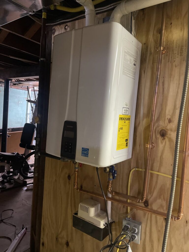 A new tankless water heater installed on a wall by Best Plumbing Heating & Cooling Contractors in Albany, NY.