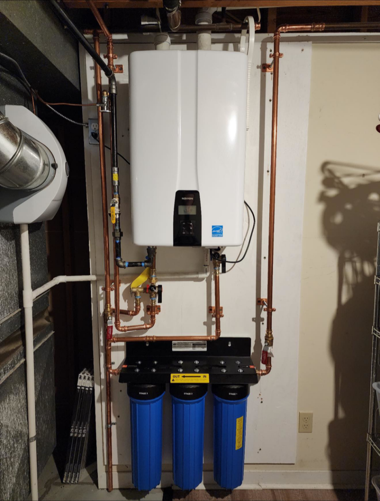 A newly installed tankless water heater system by Freedom Heating & Cooling in Lathrop, MO.