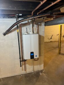 A newly installed tankless water heater with copper piping in a basement by Furnace Doctors Heating & Air Conditioning LLC in Champaign, IL