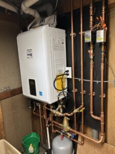 A newly installed tankless water heater system with copper piping and electrical work by NorthStar Services in South Haven, MN