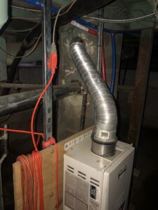A tankless water heater with flexible exhaust ducting installed by Ohio City Heating and Cooling in Cleveland, OH.