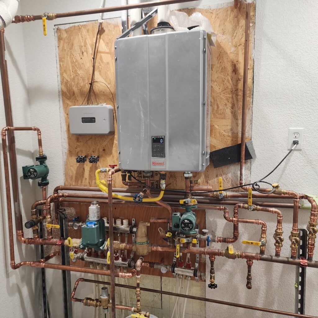 A newly installed tankless water heater and copper piping by Reading Plumbing, Heating & Air Conditioning in Roswell, NM