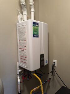 A tankless water heater installed on a wall with visible plumbing and gas lines by S&S Mechanical in St. George, UT