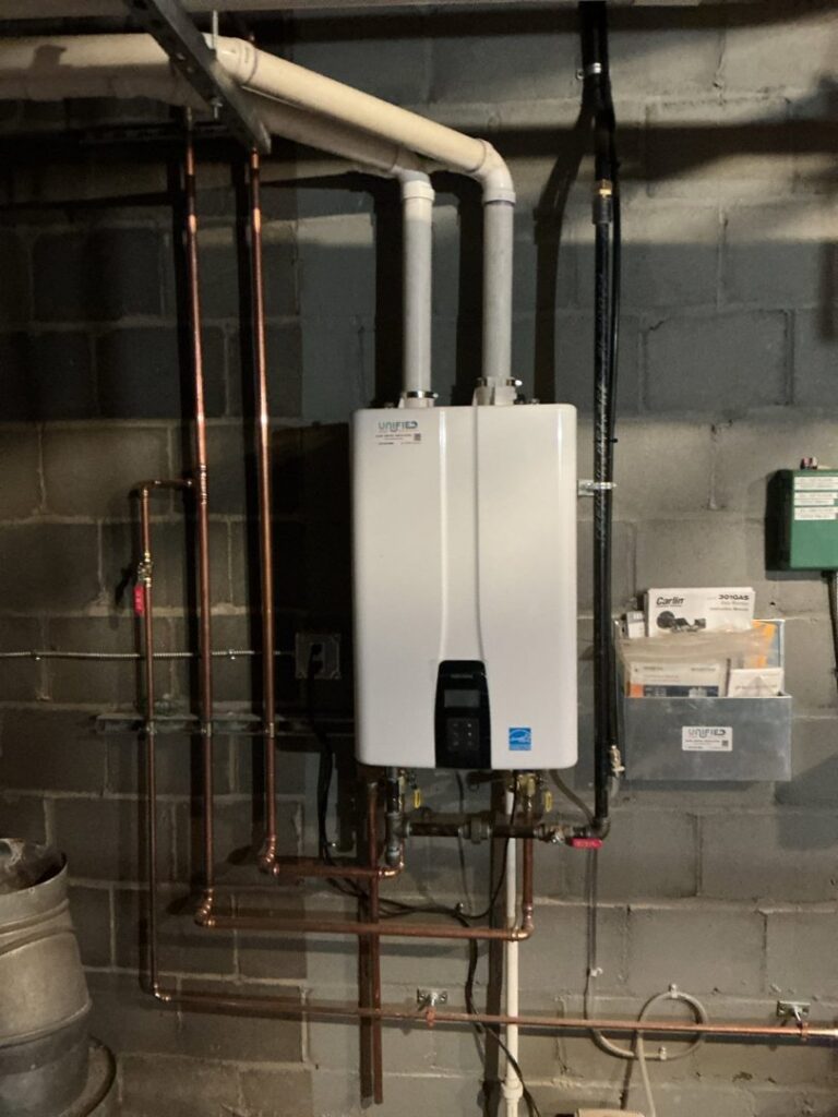A new tankless water heater installation with copper piping by Unified Home Solutions in Stamford, CT.