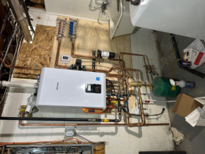 A comprehensive view of a tankless water heater and manifold system installation by Cardinal Repairs in Canton, OH