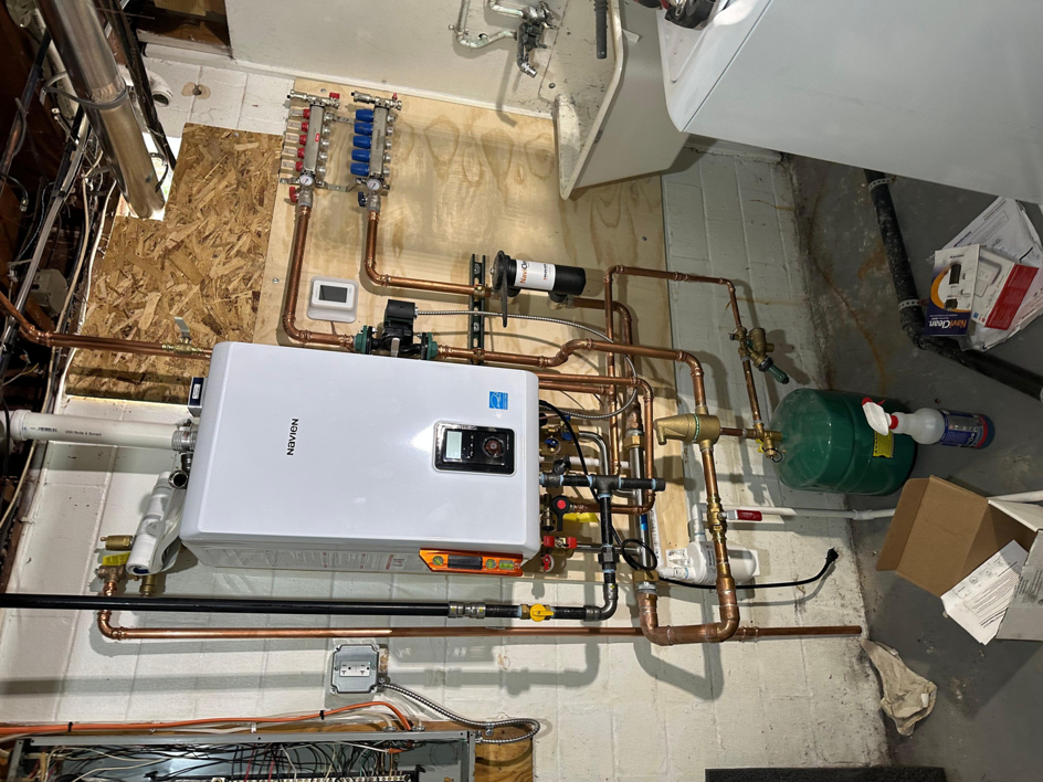 A comprehensive view of a tankless water heater and manifold system installation by Cardinal Repairs in Canton, OH