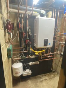 Detailed view of a tankless water heater and copper piping system installed by Air We Are in Toms River, NJ.