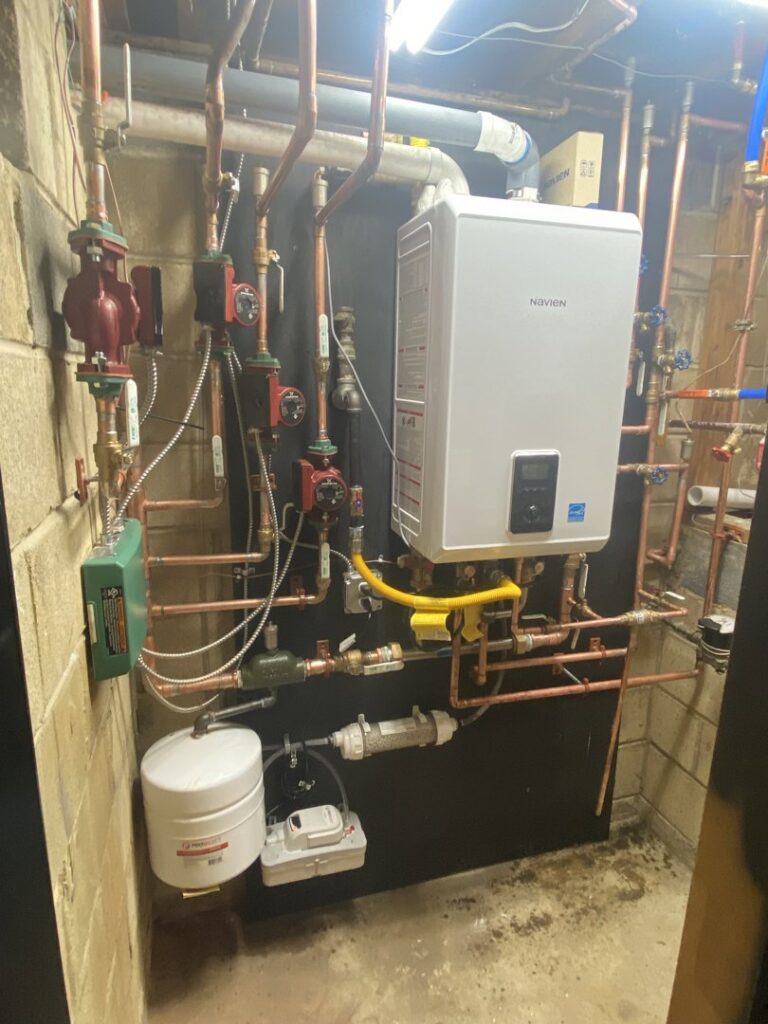 Detailed view of a tankless water heater and copper piping system installed by Air We Are in Toms River, NJ.