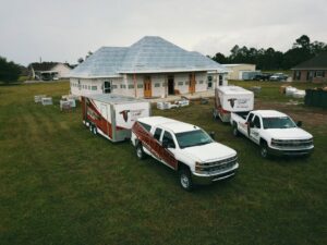 Target Temp, LLC trucks and trailers at a new home construction site in Houma, LA, ready for HVAC installation.