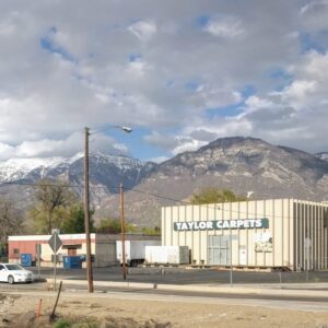 The Taylor Carpets & Flooring building with scenic mountains in the background in Provo, UT