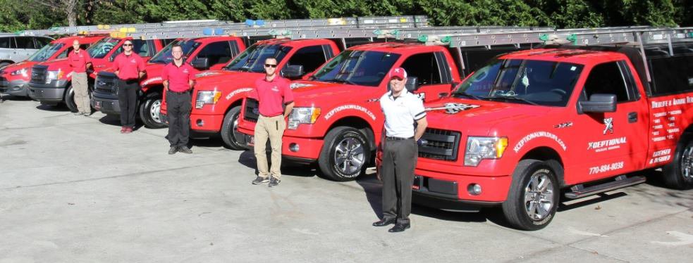 The team and fleet of red wildlife removal trucks from Xceptional Wildlife Removal Jacksonville, FL, ready for service.