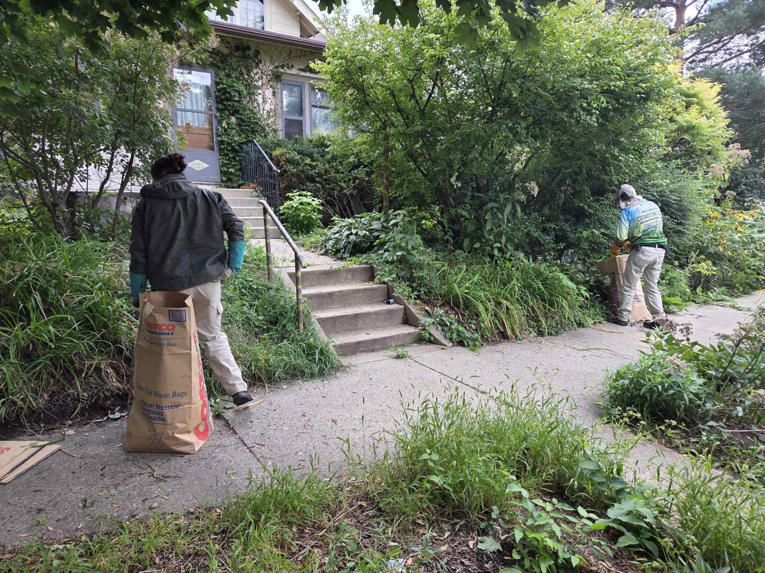 A Grounded Earth team bagging yard waste during a property cleanup service in Minneapolis, MN.