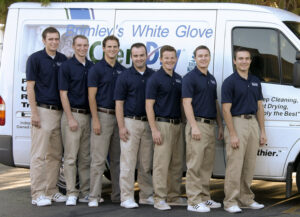 A team of Brimley's White Glove Chem-Dry technicians stands in uniform in front of a service van in Mesa, AZ.