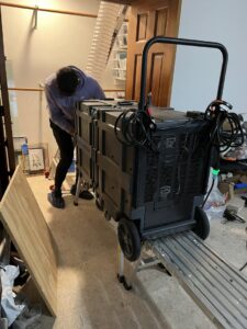A technician adjusting duct sealing equipment on a ladder for Green Seal Energy in Overland Park, KS.