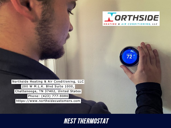 A technician adjusting a Nest smart thermostat for Air Conditioning Repair Service in Chattanooga, TN
