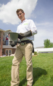 A technician from EDGE - The Service Company applying a lawn treatment in Bridgeview, IL.